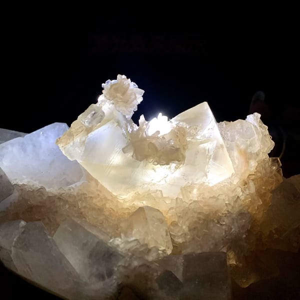 Large apophyllite plate with pink stilbite and calcite from India, close-up of the crystal faces