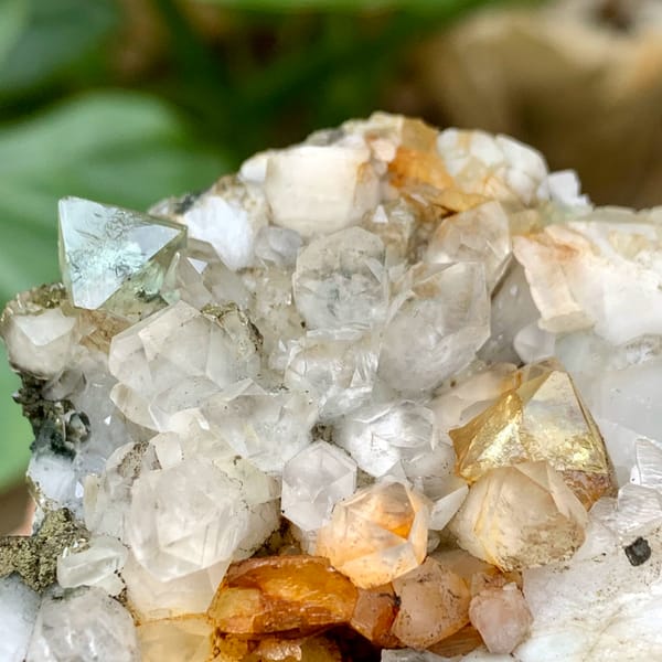 Yellow and green fluorite octahedra on white quartz from Fujian, China, close-up of the crystal faces