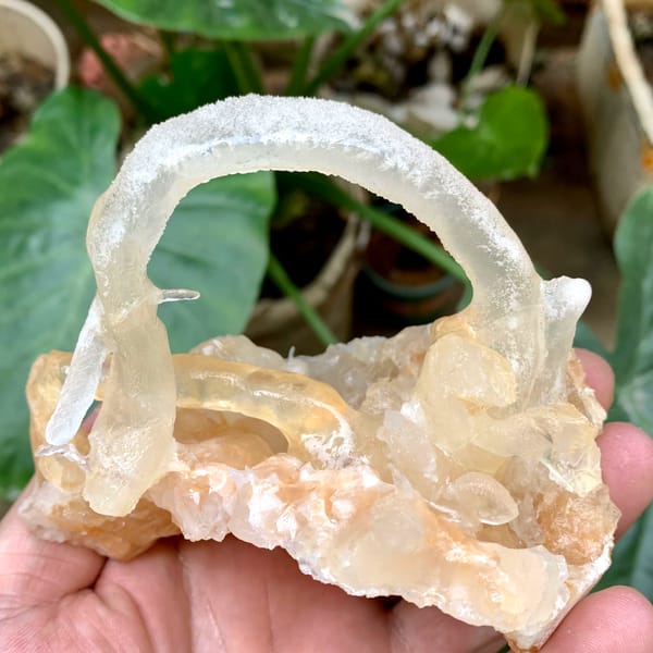 Arched calcite stalactite over crystal cluster from Yunnan, China, second angle