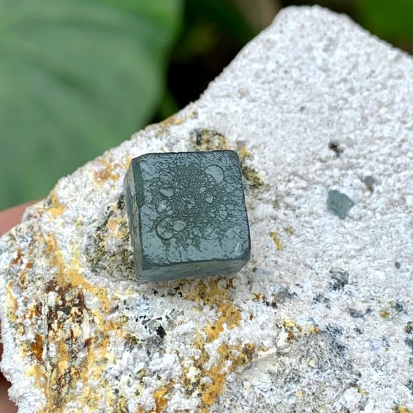 Single green fluorite cube on pale quartz matrix from Inner Mongolia, China, reverse side