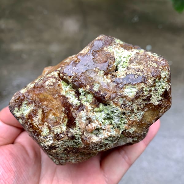 Large brown-green demantoid garnet crystal floater from Mali, top view