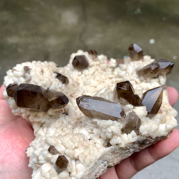 Dark smoky quartz points on cream feldspar mound from Fujian, China, reverse side