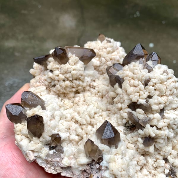 Dark smoky quartz points on cream feldspar mound from Fujian, China, top view