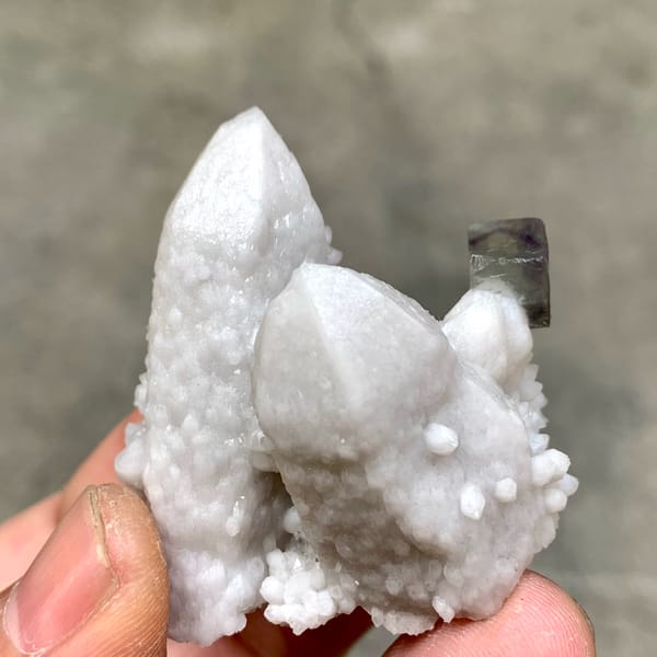 Pale quartz spire with small purple fluorite cubes from Inner Mongolia, China, second angle