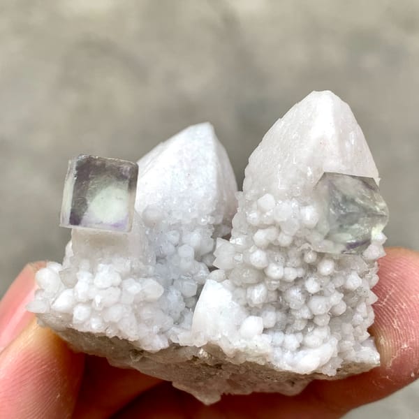 Pale quartz spire with small purple fluorite cubes from Inner Mongolia, China, top view