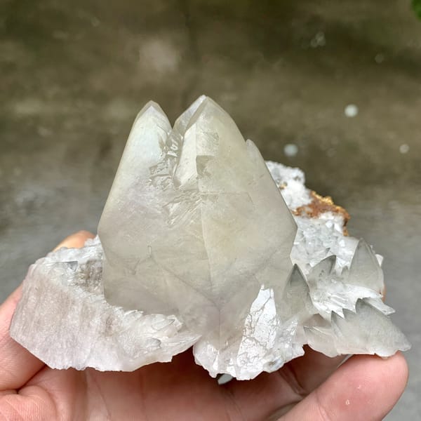 Large twinned calcite crystal with sketch-pattern lines from Hubei, China, detail of the matrix contact