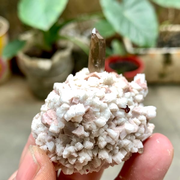 Smoky quartz point on pale feldspar with garnet from Fujian, China, second angle