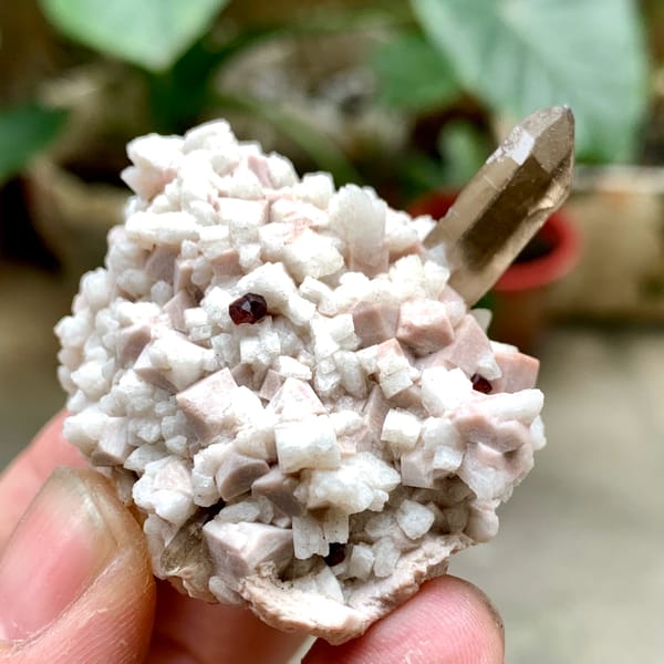 Smoky quartz point on pale feldspar with garnet from Fujian, China, reverse side
