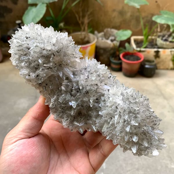 Long plate of sharp-pointed calcite crystals with pyrite from Hubei, China, close-up of the crystal faces