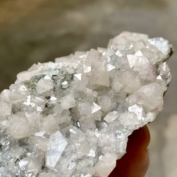 Pale scheelite crystals with white calcite from Yaogangxian Mine, Hunan, China, close-up of the crystal faces