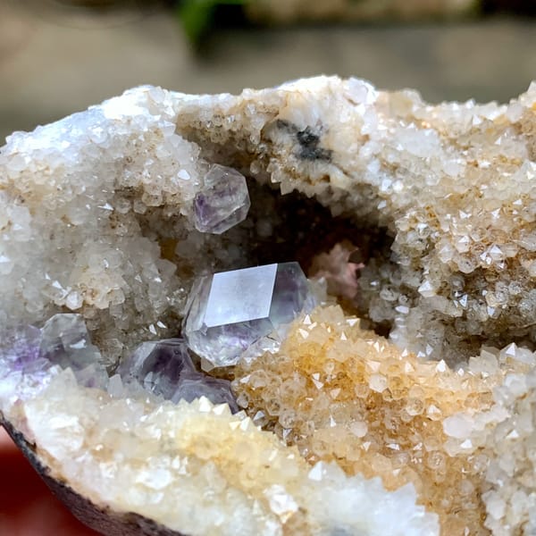 Quartz geode with purple fluorite crystal inside from Fujian, China, close-up of the crystal faces