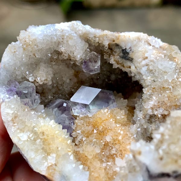 Quartz geode with purple fluorite crystal inside from Fujian, China, top view