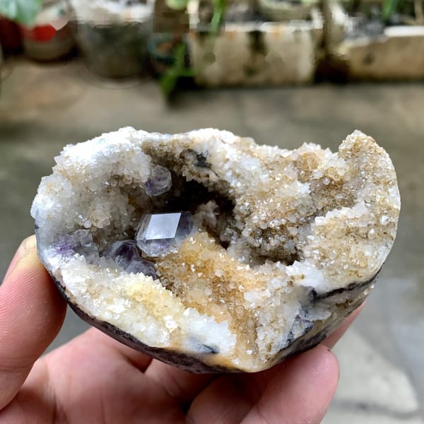 Quartz geode with purple fluorite crystal inside from Fujian, China, detail of the matrix contact
