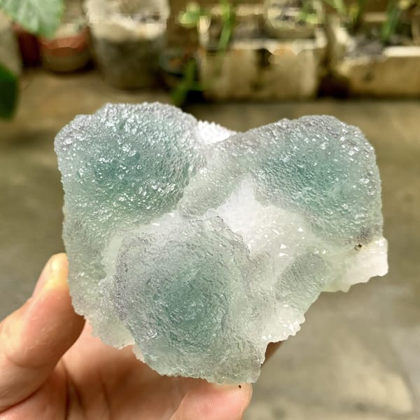Large stepped green fluorite mounds with sugary skin from Fujian, China, detail of the matrix contact