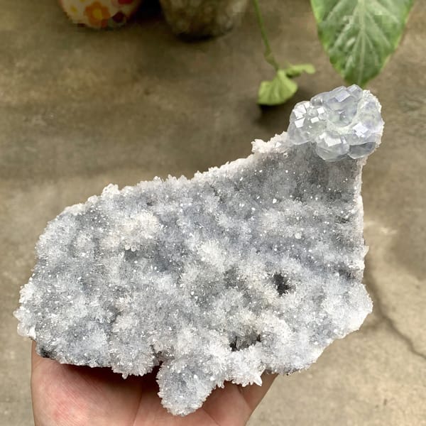 Long plate of sparkling quartz druse with blue-cored fluorite from Fujian, China, detail of the matrix contact