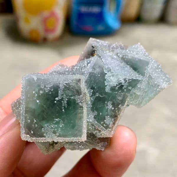 Three sugar-frosted green fluorite cubes from Fujian, China, close-up of the crystal faces