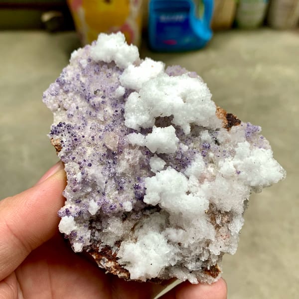 Purple yttrofluorite with white gypsum crust from Guizhou, China, top view