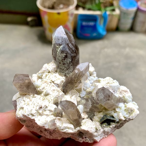 Smoky quartz points with chlorite on cream feldspar from Fujian, China, reverse side