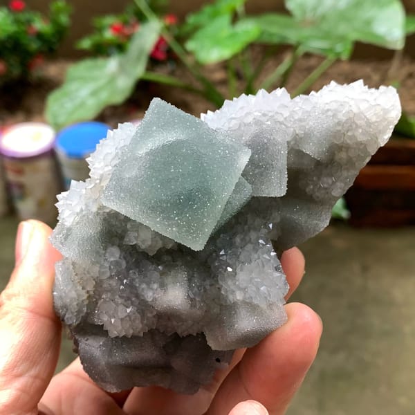 Bright green fluorite cube on sparkling quartz druse from Fujian, China, second angle