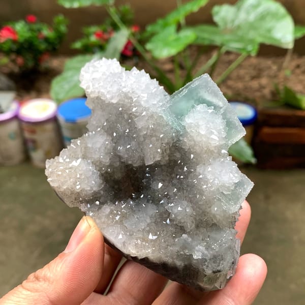 Bright green fluorite cube on sparkling quartz druse from Fujian, China, reverse side