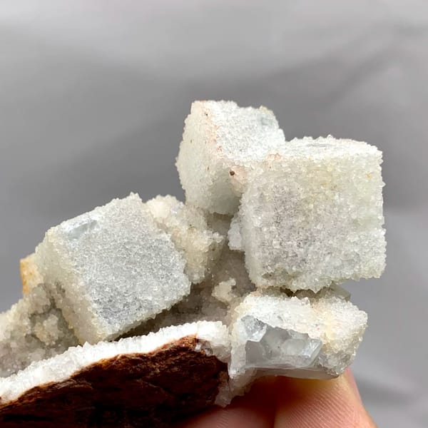 White sugar-frosted fluorite cubes on quartz from Fujian, China, close-up of the crystal faces