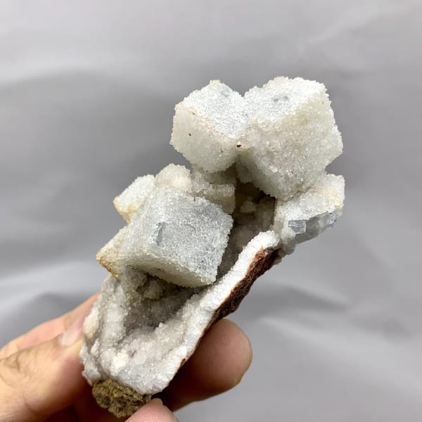 White sugar-frosted fluorite cubes on quartz from Fujian, China, detail of the matrix contact