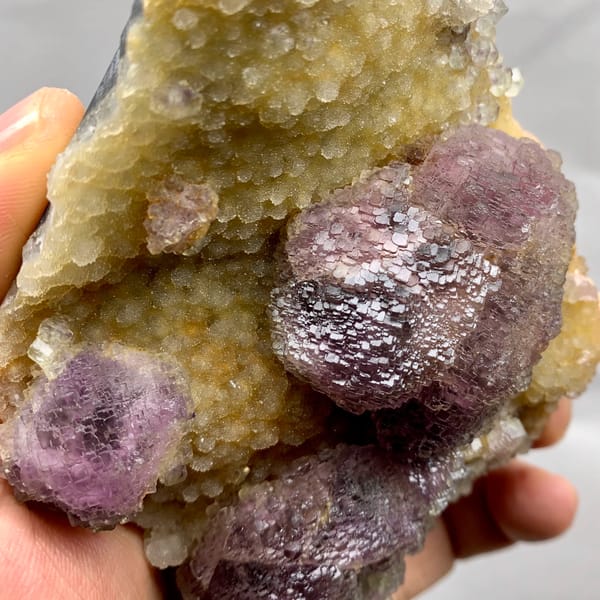 Purple mosaic fluorite balls on golden quartz druse from Fujian, China, second angle