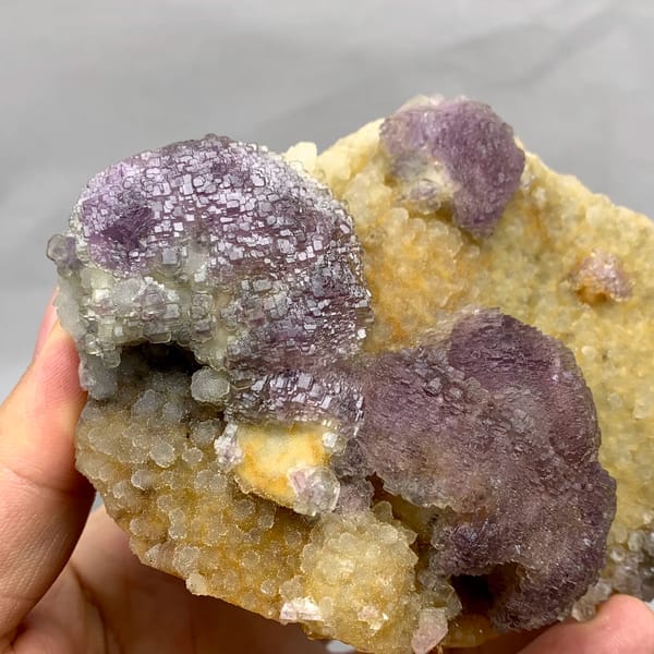 Purple mosaic fluorite balls on golden quartz druse from Fujian, China, top view