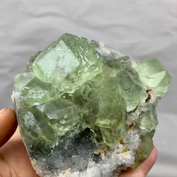 Cluster of large glassy sea-green fluorite cubes from Fujian, China, close-up of the crystal faces