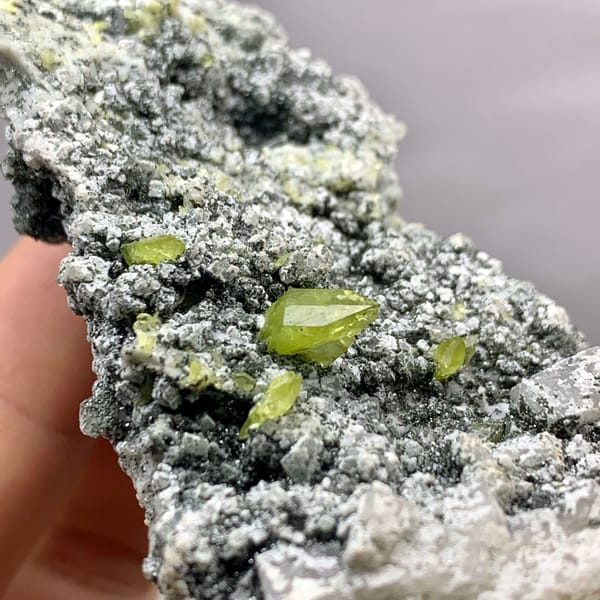 Yellow-green titanite crystals on green chlorite plate from Pakistan, close-up of the crystal faces