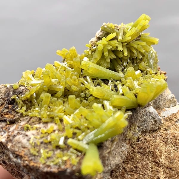 Matcha-green pyromorphite prisms on brown matrix from Guangxi, China, close-up of the crystal faces