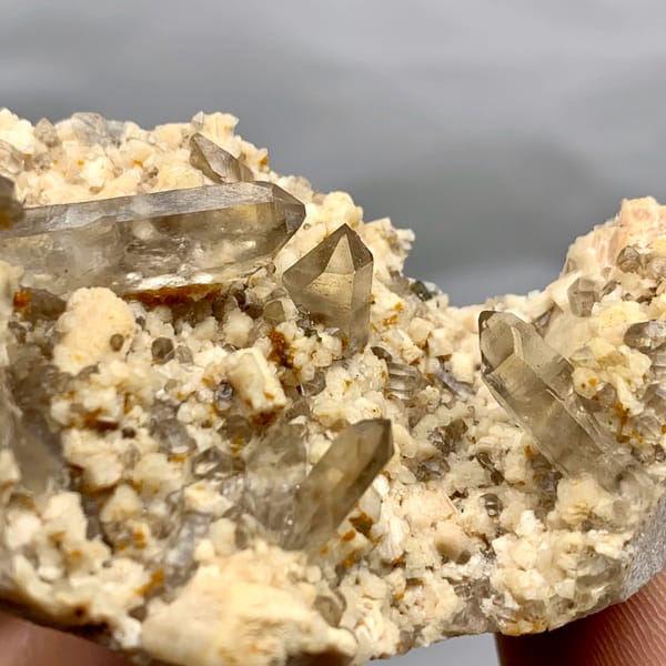 Smoky quartz points in hollow of cream feldspar from Fujian, China, second angle