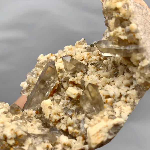 Smoky quartz points in hollow of cream feldspar from Fujian, China, reverse side