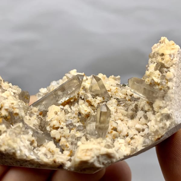 Smoky quartz points in hollow of cream feldspar from Fujian, China, top view