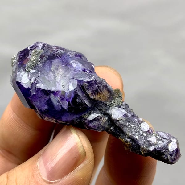 Tadpole-shaped violet fluorite floater with grey quartz from Fujian, China, second angle