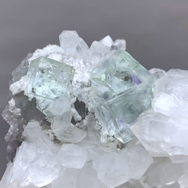 Glassy pale-green fluorite cubes in white quartz geode from Zhejiang, China, second angle