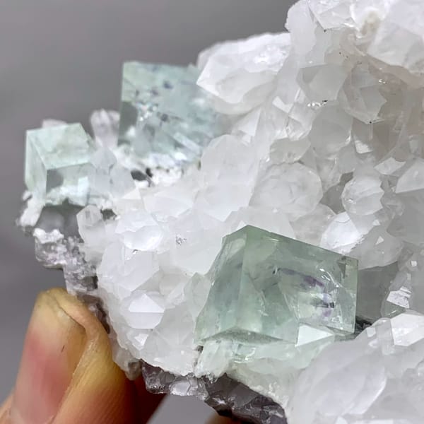 Glassy pale-green fluorite cubes in white quartz geode from Zhejiang, China, reverse side