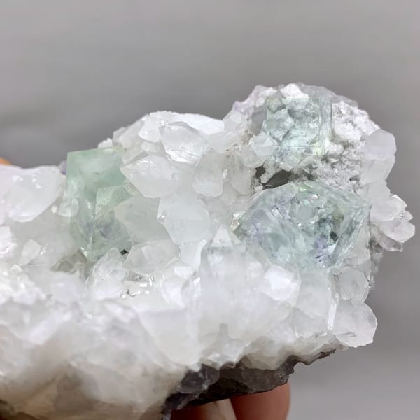 Glassy pale-green fluorite cubes in white quartz geode from Zhejiang, China, top view