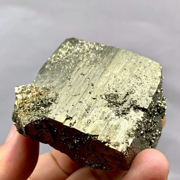 Heavy brass-gold pyrite block with striated faces from Yaogangxian Mine, Hunan, China