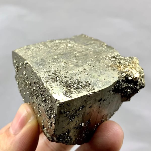Heavy brass-gold pyrite block with striated faces from Yaogangxian Mine, Hunan, China, close-up of the crystal faces