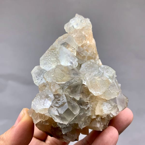 Etched white fluorite octahedra with calcite from Inner Mongolia, China, close-up of the crystal faces