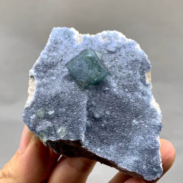Teal fluorite cube on dusty lavender recrystallised fluorite from Inner Mongolia, China, reverse side