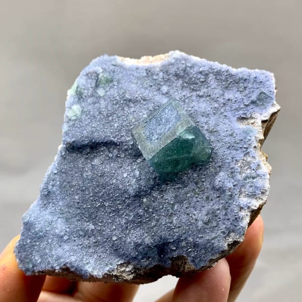 Teal fluorite cube on dusty lavender recrystallised fluorite from Inner Mongolia, China, top view