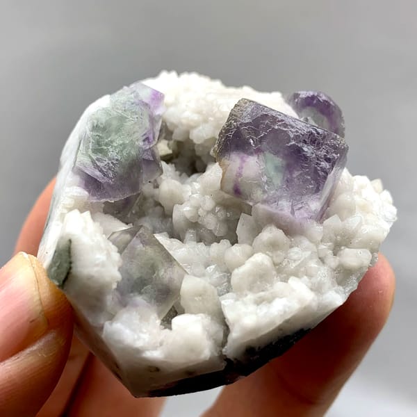 Purple-edged green fluorite cubes in white quartz from Inner Mongolia, China, close-up of the crystal faces