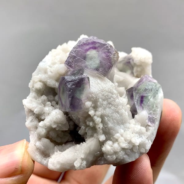 Purple-edged green fluorite cubes in white quartz from Inner Mongolia, China, reverse side