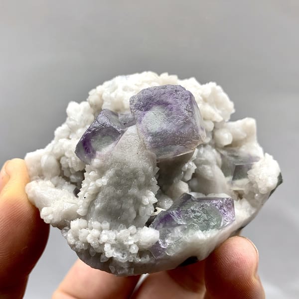 Purple-edged green fluorite cubes in white quartz from Inner Mongolia, China, detail of the matrix contact