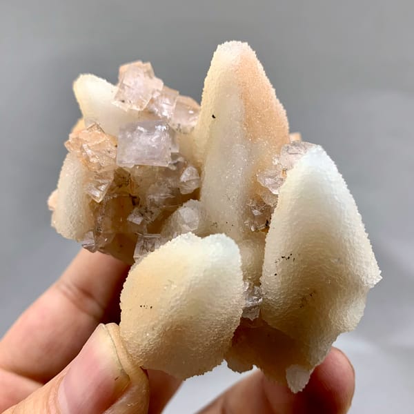 Peach-toned quartz pseudomorphs after calcite from Zhejiang, China, close-up of the crystal faces
