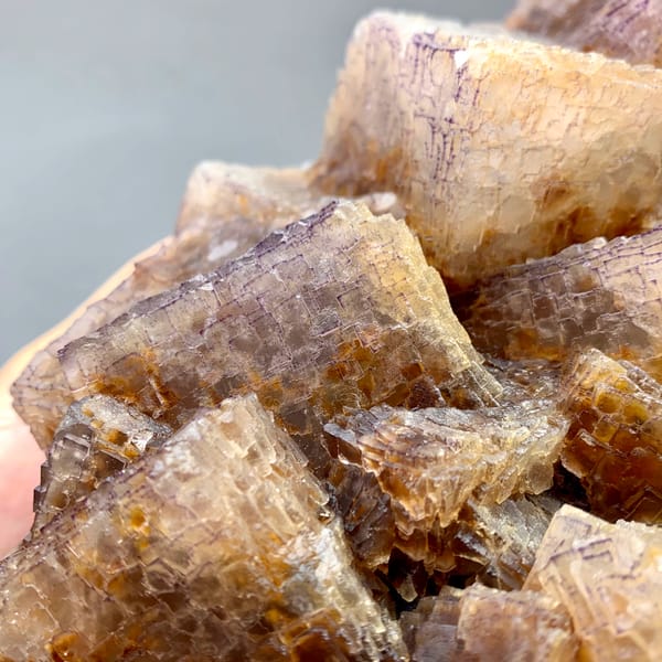 Large block of purple and yellow QR-code patterned fluorite cubes from Guizhou, China, close-up of the crystal faces