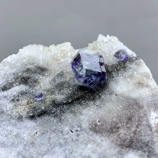 Single blue fluorite crystal on grey quartz druse from Fujian, China, second angle