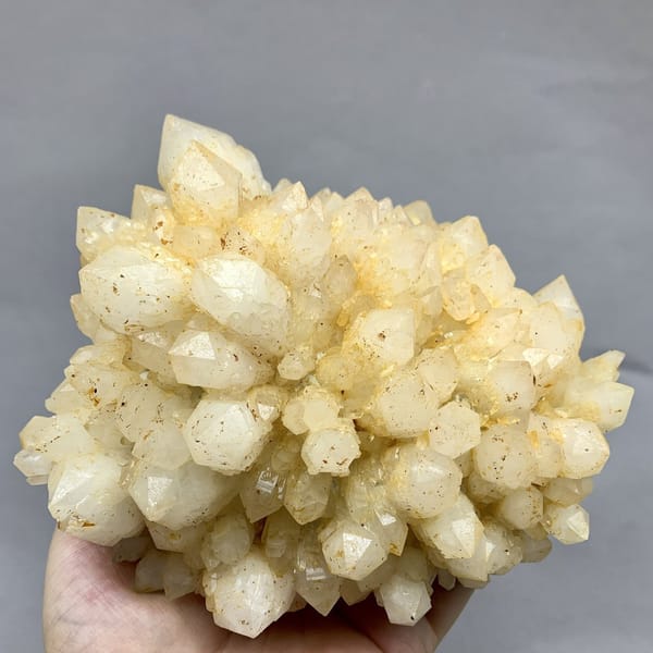 Large yellow pineapple-textured quartz cluster from Fujian, China, detail of the matrix contact